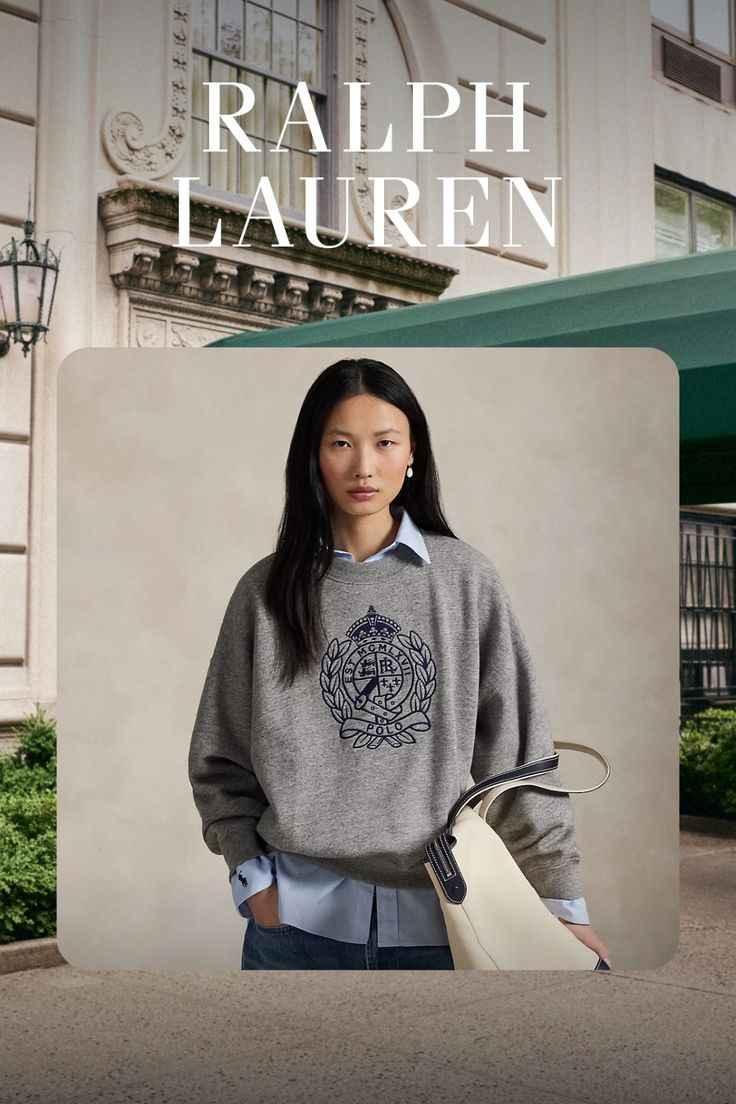 Ralph Lauren ad featuring woman in gray Polo sweater and blue shirt carrying white handbag in urban setting