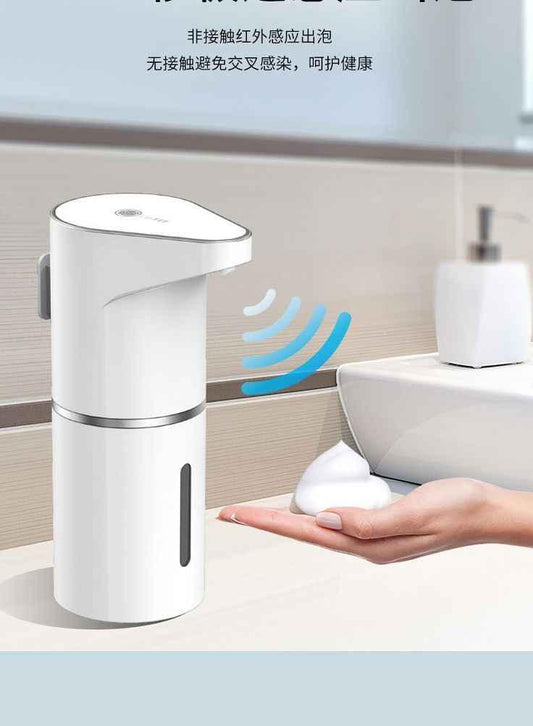 Touchless automatic foam soap dispenser dispensing foam onto hand in modern bathroom