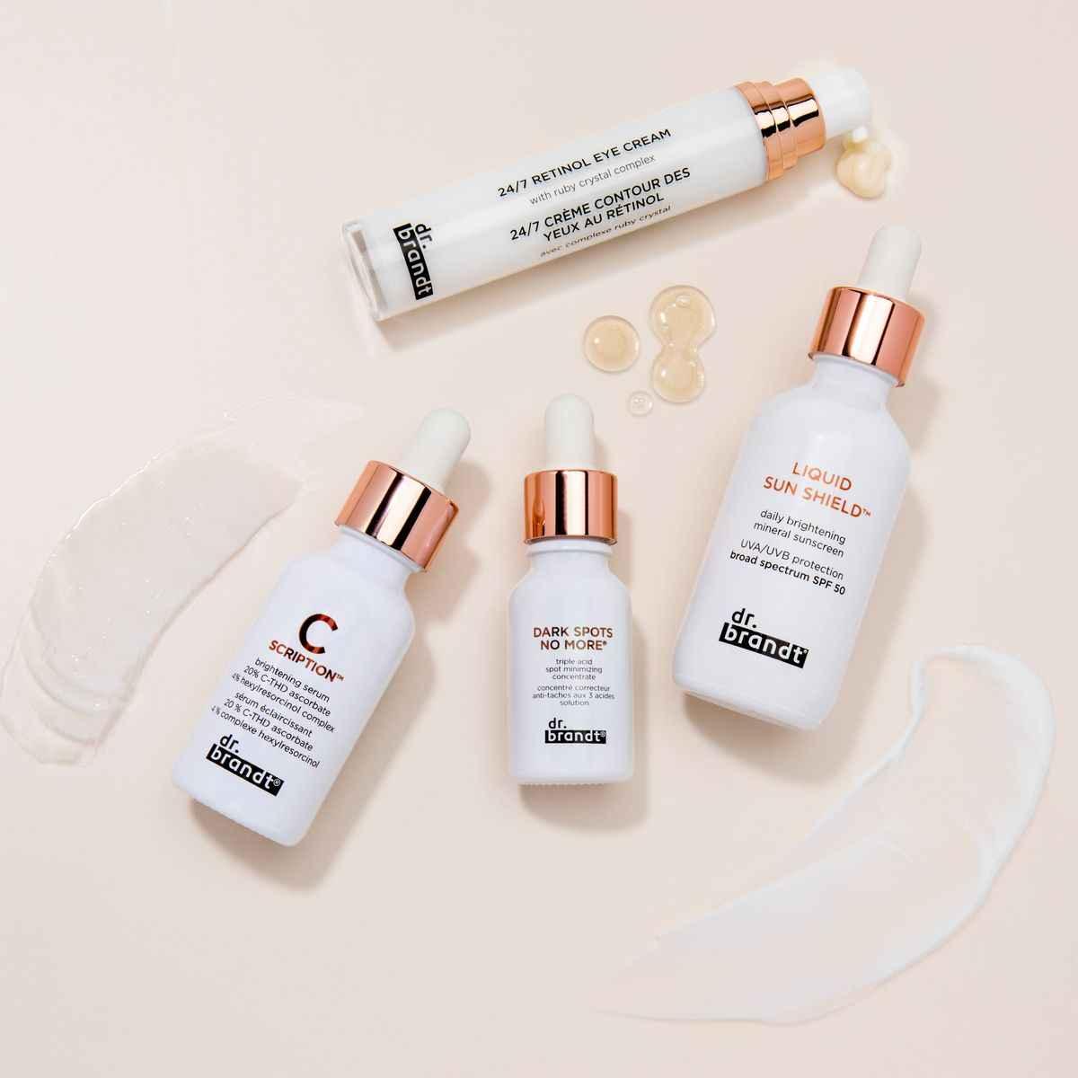 Dr. Brandt skincare products including retinol eye cream, brightening serum, dark spot corrector, and SPF 50 sunscreen on beige background
