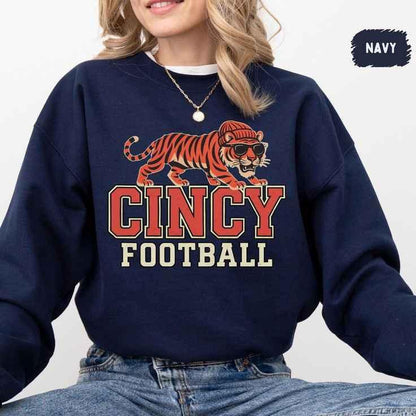 Navy sweatshirt with a tiger wearing sunglasses and a beanie, text 'CINCY FOOTBALL', casual women's outfit