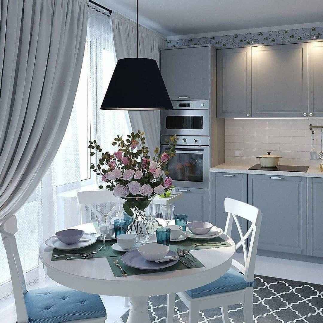 Modern kitchen with a dining table set and decorative elements.