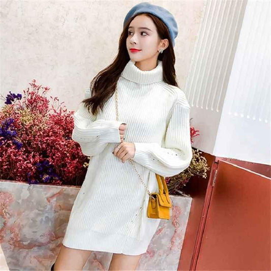 Young woman wearing white turtleneck knitted sweater dress and blue beret with yellow shoulder bag indoors