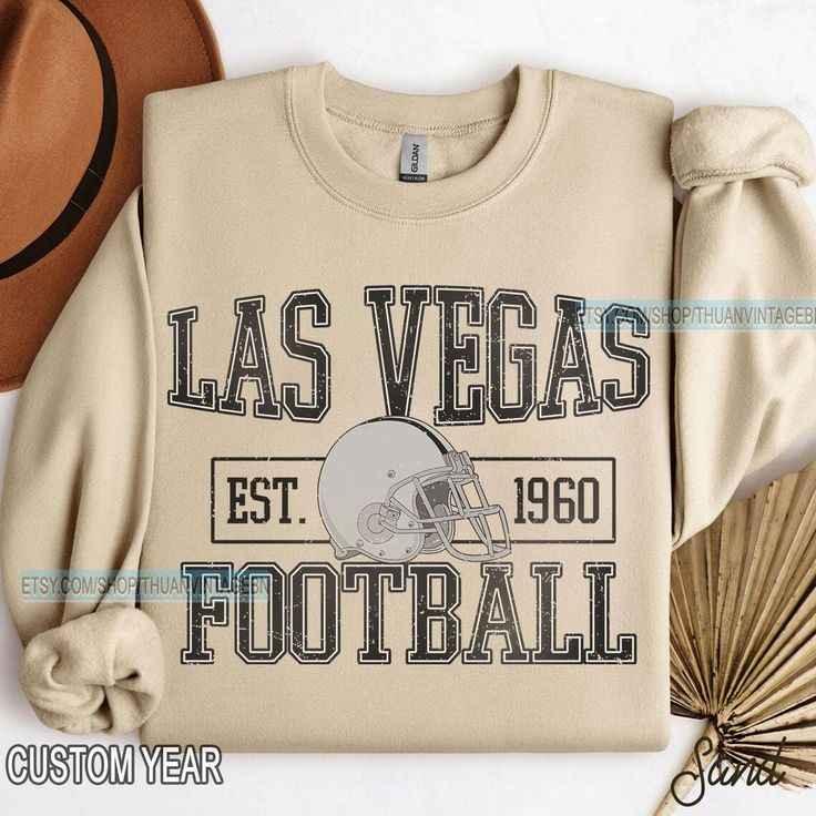 Beige Las Vegas football sweatshirt with vintage helmet graphic and custom year est. 1960