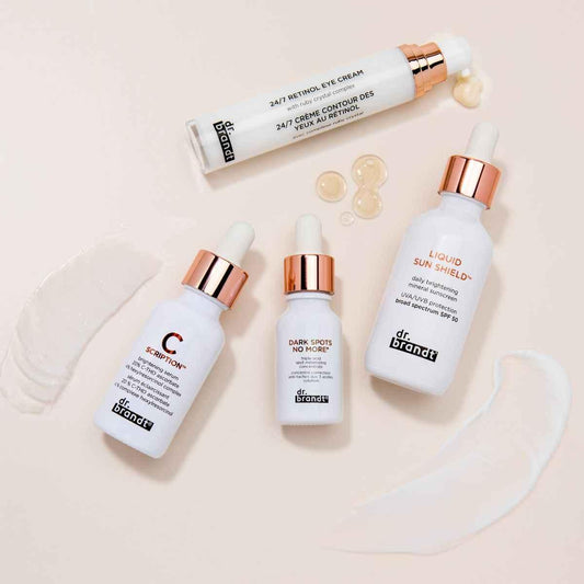 Dr. Brandt skincare products including retinol eye cream, brightening serum, dark spot corrector, and SPF 50 sunscreen on beige background