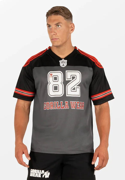 Athletic man wearing Gorilla Wear black and gray sports jersey with number 82 and red stripes